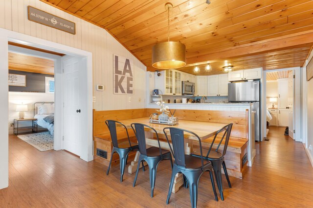 61 Beechwoods Rd, Oxford, ME 04270 - dining room featuring wood ceiling, vaulted ceiling, light wood-style flooring, and wood walls