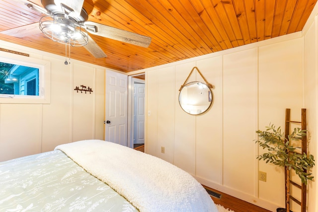 61 Beechwoods Rd, Oxford, ME 04270 - bedroom featuring wood ceiling, a decorative wall, and wood finished floors