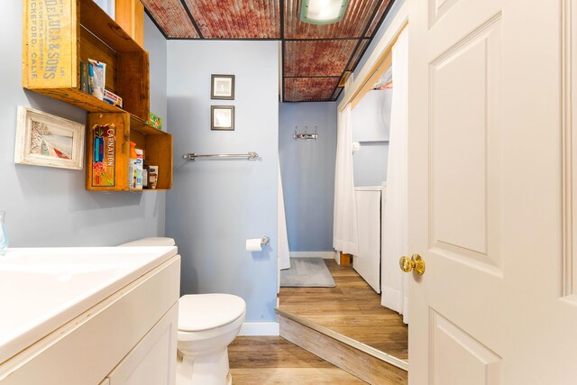 61 Beechwoods Rd, Oxford, ME 04270 - bathroom featuring wood finished floors, toilet, vanity, and baseboards
