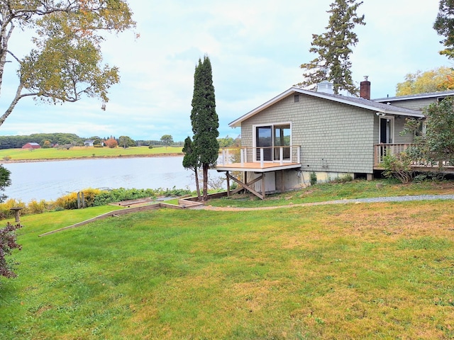 58 Back Shore Rd, Castine, ME 04421 - back of house featuring a chimney, a deck with water view, and a yard