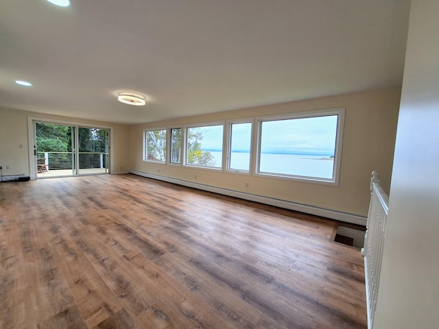58 Back Shore Rd, Castine, ME 04421 - unfurnished living room featuring a baseboard radiator, wood finished floors, recessed lighting, and a baseboard heating unit
