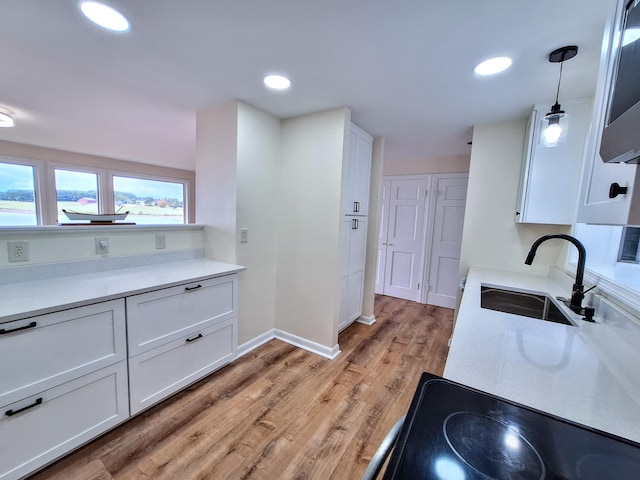 58 Back Shore Rd, Castine, ME 04421 - kitchen with white cabinetry, a sink, stovetop, and recessed lighting