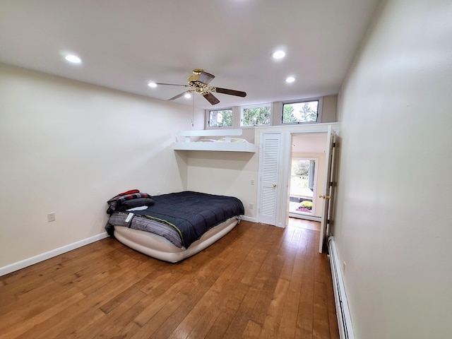 58 Back Shore Rd, Castine, ME 04421 - bedroom with baseboard heating, recessed lighting, wood-type flooring, baseboards, and ceiling fan