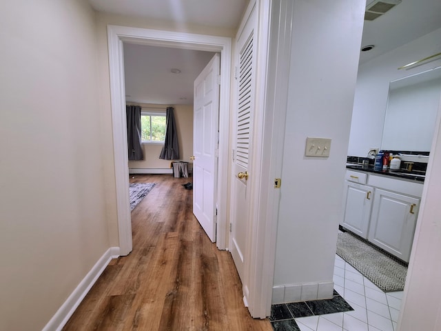 58 Back Shore Rd, Castine, ME 04421 - hallway with baseboard heating, baseboards, and wood finished floors