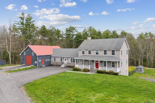 20 Motorcycle Dr, Windham, ME 04062 - view of front of property with a porch, a shingled roof, a chimney, and a front lawn