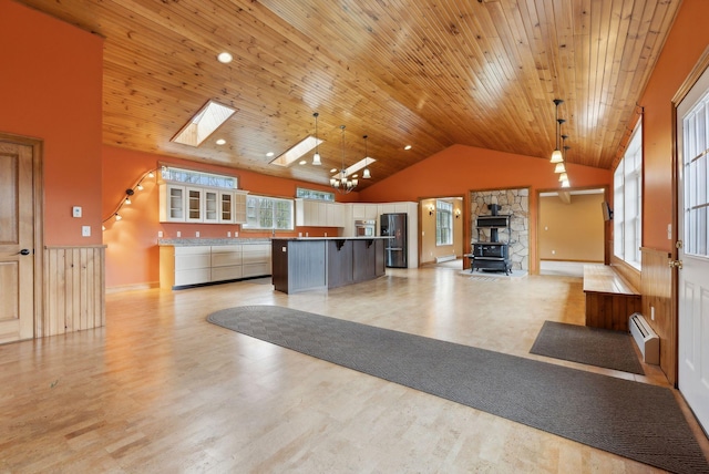 20 Motorcycle Dr, Windham, ME 04062 - welcome area featuring a wood stove, wooden ceiling, a skylight, and high vaulted ceiling