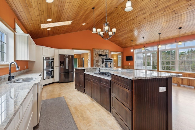 20 Motorcycle Dr, Windham, ME 04062 - kitchen featuring appliances with stainless steel finishes, a sink, white cabinets, a skylight, and dark brown cabinets
