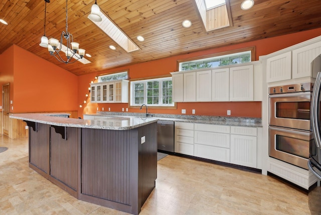 20 Motorcycle Dr, Windham, ME 04062 - kitchen featuring stainless steel appliances, a skylight, wood ceiling, a chandelier, and white cabinets
