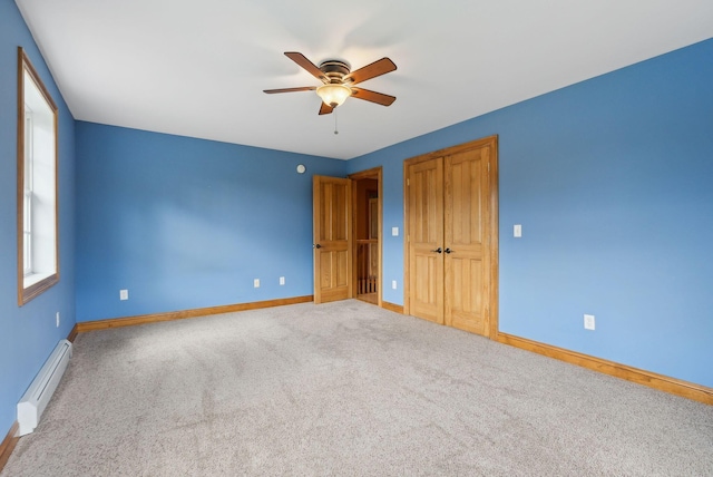 20 Motorcycle Dr, Windham, ME 04062 - unfurnished bedroom featuring a baseboard heating unit, baseboards, carpet floors, ceiling fan, and a closet