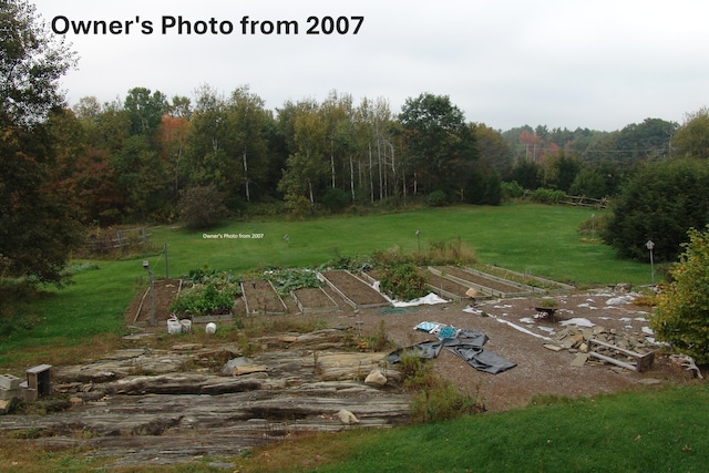 320 Spring Rd, Augusta, ME 04330 - view of grassy yard with a vegetable garden and a view of trees