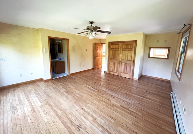 320 Spring Rd, Augusta, ME 04330 - unfurnished bedroom featuring baseboard heating, light wood finished floors, and a closet