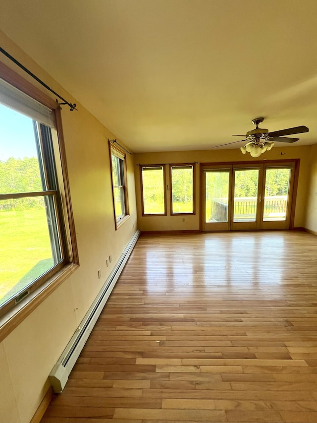 320 Spring Rd, Augusta, ME 04330 - unfurnished room with a baseboard radiator, healthy amount of natural light, and light wood-style flooring