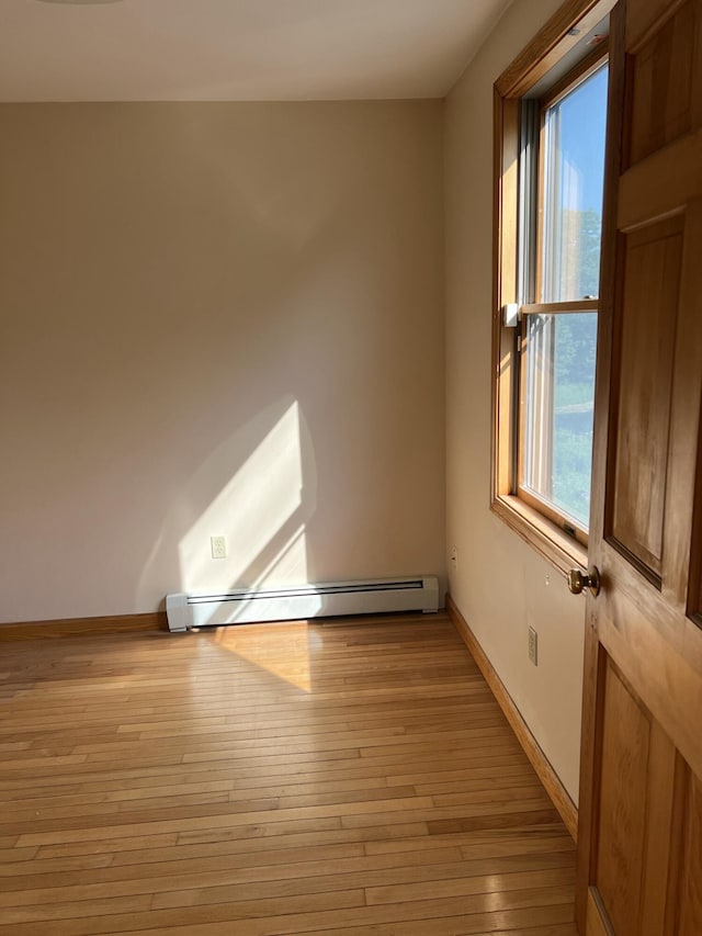 320 Spring Rd, Augusta, ME 04330 - unfurnished room featuring a baseboard radiator, healthy amount of natural light, and light wood finished floors