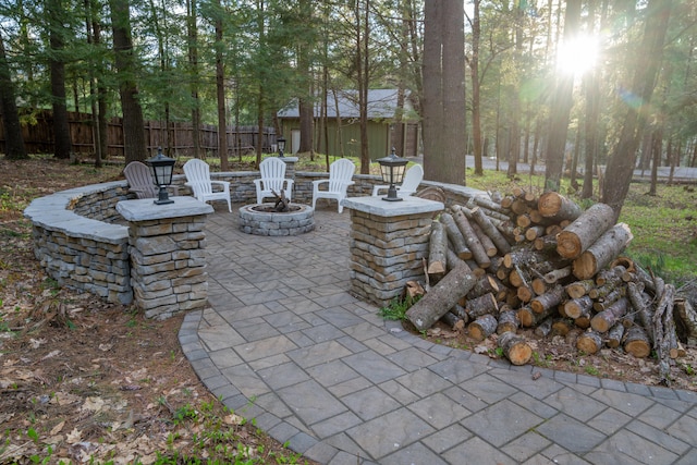 106 Webb River Dr, Dixfield, ME 04224 - view of patio with an outdoor fire pit, fence, and an outbuilding