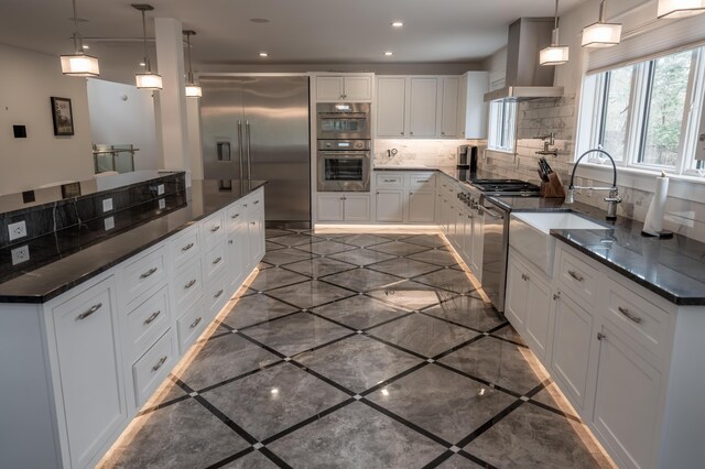 106 Webb River Dr, Dixfield, ME 04224 - kitchen with appliances with stainless steel finishes, wall chimney exhaust hood, a sink, inlaid floor details, and tasteful backsplash