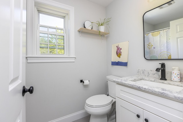 full bathroom with vanity, toilet, and baseboards