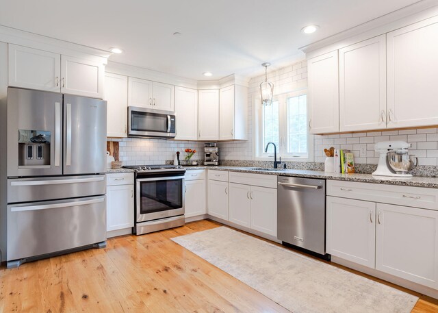 22 Lilac Ln, Gorham, ME 04038 - kitchen featuring stainless steel appliances, a sink, white cabinets, tasteful backsplash, and recessed lighting