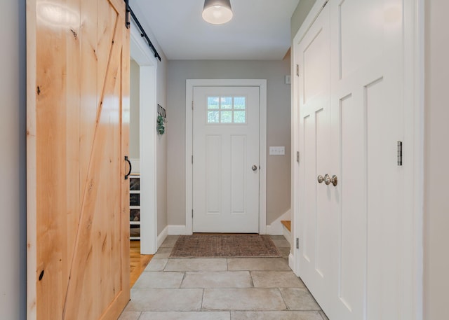 22 Lilac Ln, Gorham, ME 04038 - entrance foyer with a barn door, baseboards, and light tile patterned floors