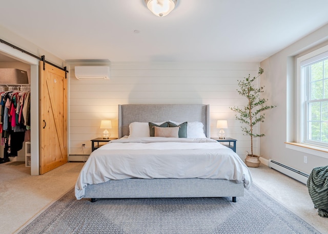 22 Lilac Ln, Gorham, ME 04038 - carpeted bedroom with baseboard heating, a wall mounted AC, a walk in closet, a barn door, and a closet