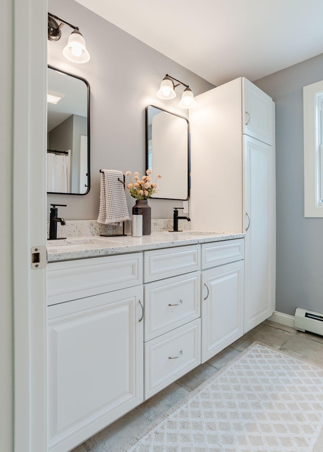 22 Lilac Ln, Gorham, ME 04038 - bathroom featuring double vanity and baseboard heating