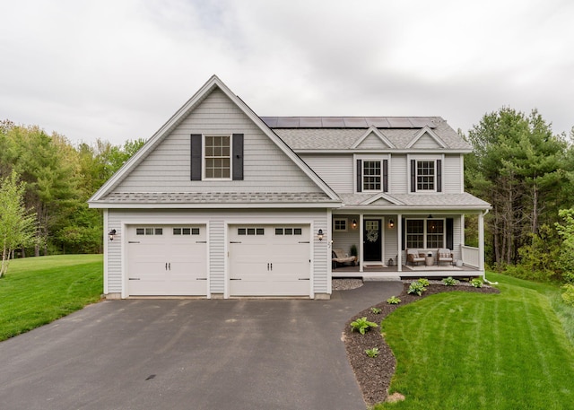 22 Lilac Ln, Gorham, ME 04038 - view of front of house featuring covered porch, a front lawn, roof mounted solar panels, driveway, and a shingled roof