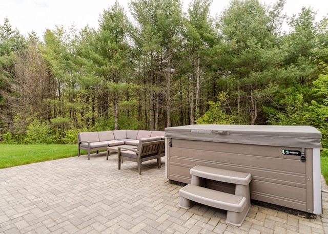 22 Lilac Ln, Gorham, ME 04038 - view of patio / terrace featuring a hot tub, an outdoor living space, and a forest view