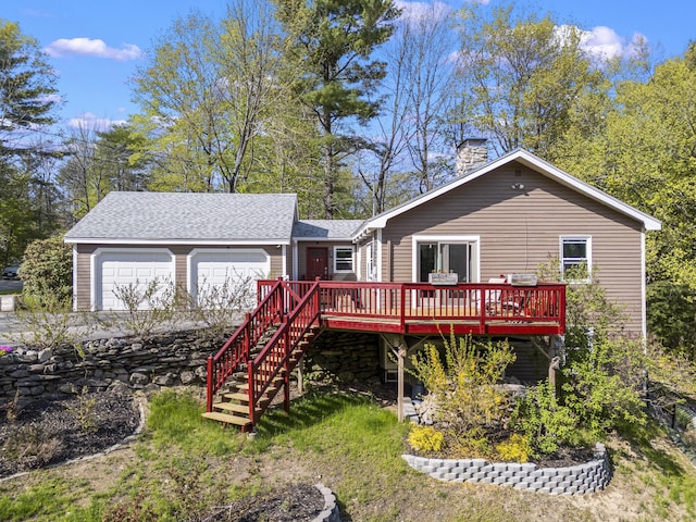 591 Eight Rod Rd, Augusta, ME 04330 - back of property with a wooden deck, a garage, roof with shingles, a chimney, and stairs