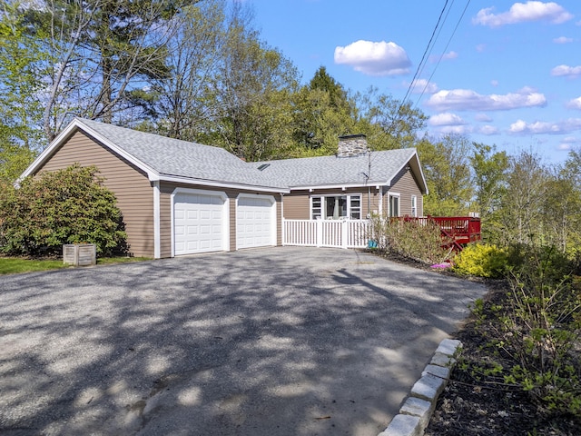591 Eight Rod Rd, Augusta, ME 04330 - view of front of house featuring asphalt driveway, an attached garage, a chimney, and a shingled roof
