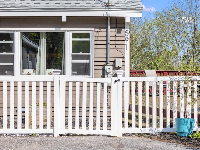 591 Eight Rod Rd, Augusta, ME 04330 - view of home's exterior featuring roof with shingles and a gate