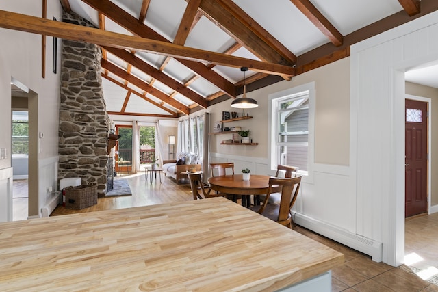 591 Eight Rod Rd, Augusta, ME 04330 - tiled dining room featuring a baseboard heating unit, plenty of natural light, beam ceiling, a decorative wall, and wainscoting