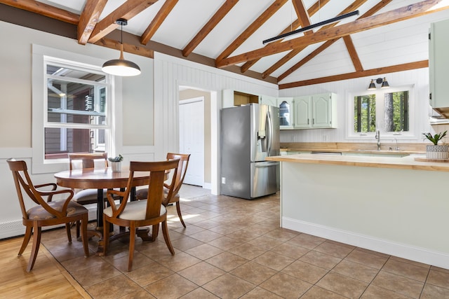 591 Eight Rod Rd, Augusta, ME 04330 - dining room featuring a decorative wall, light tile patterned floors, and a wainscoted wall