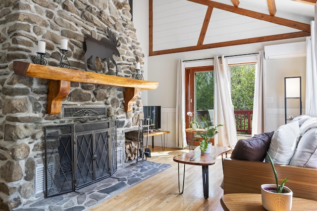 591 Eight Rod Rd, Augusta, ME 04330 - living area with a wall mounted AC, wood finished floors, a fireplace, and wainscoting