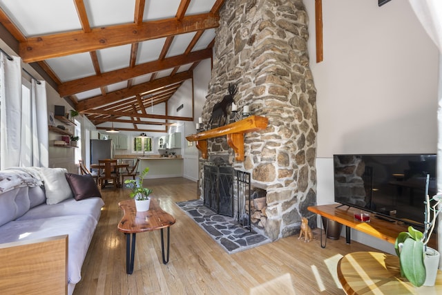 591 Eight Rod Rd, Augusta, ME 04330 - living area with wood finished floors, high vaulted ceiling, beam ceiling, a fireplace, and baseboards