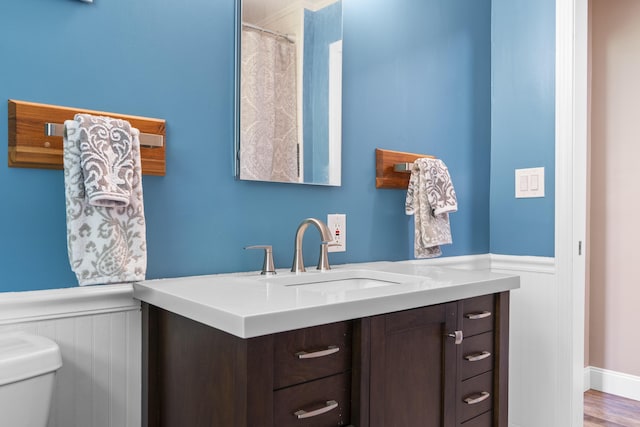 591 Eight Rod Rd, Augusta, ME 04330 - bathroom featuring wainscoting, vanity, and toilet