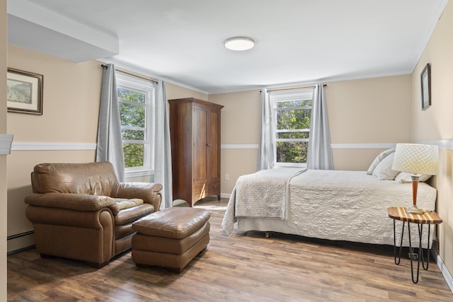 591 Eight Rod Rd, Augusta, ME 04330 - bedroom with baseboard heating, wood finished floors, crown molding, and baseboards