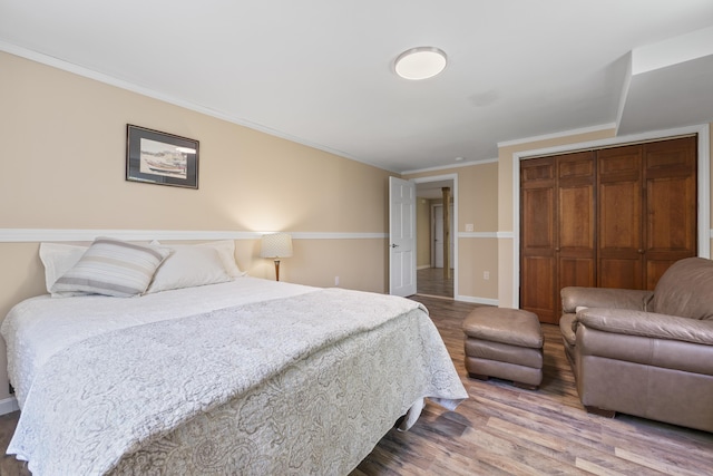 591 Eight Rod Rd, Augusta, ME 04330 - bedroom with a closet, wood finished floors, baseboards, and ornamental molding