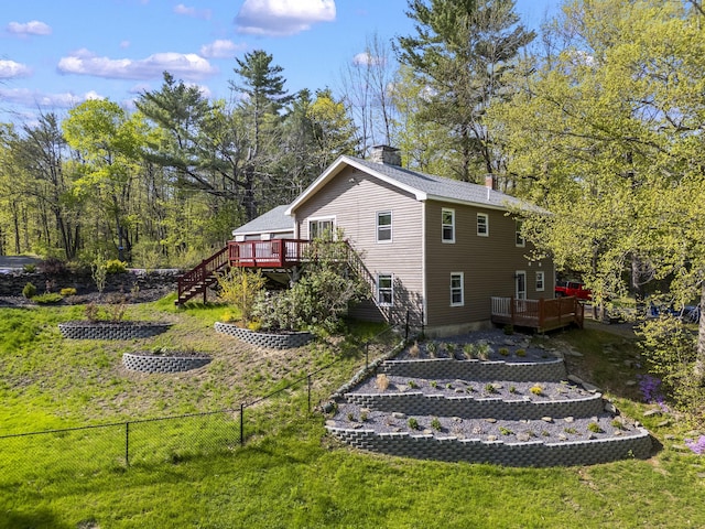 591 Eight Rod Rd, Augusta, ME 04330 - rear view of house featuring stairs, a vegetable garden, a wooden deck, and a chimney