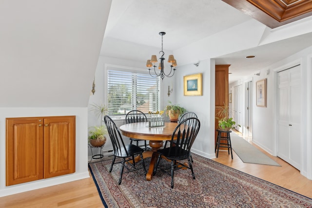 15 Christensen Ln Unit A1, Kennebunk, ME 04043 - dining area featuring light wood-style flooring, a chandelier, baseboards, and lofted ceiling