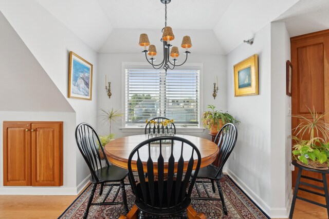15 Christensen Ln Unit A1, Kennebunk, ME 04043 - dining room featuring a chandelier, baseboards, wood finished floors, and vaulted ceiling