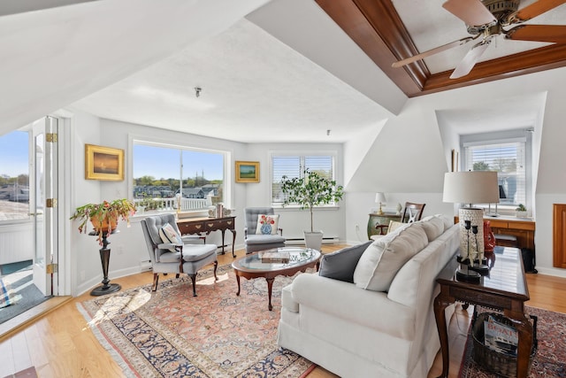 15 Christensen Ln Unit A1, Kennebunk, ME 04043 - living area featuring wood finished floors, ceiling fan, baseboards, and a baseboard radiator