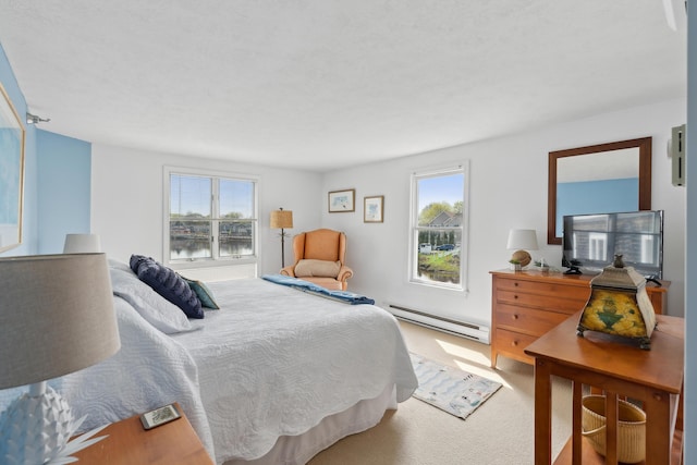 15 Christensen Ln Unit A1, Kennebunk, ME 04043 - carpeted bedroom with a baseboard heating unit and multiple windows