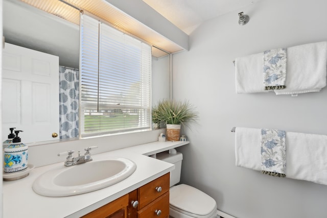 15 Christensen Ln Unit A1, Kennebunk, ME 04043 - bathroom featuring vanity, toilet, a baseboard heating unit, and a shower with curtain