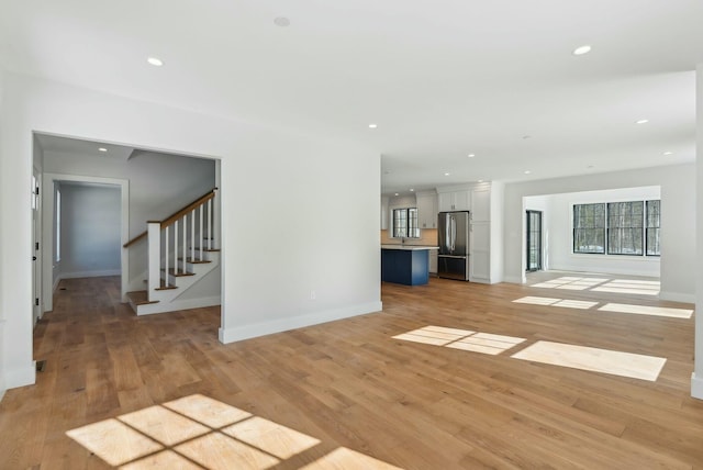 11 Acorn Ave, Kennebunkport, ME 04046 - unfurnished living room with baseboards, stairway, recessed lighting, and light wood-style flooring