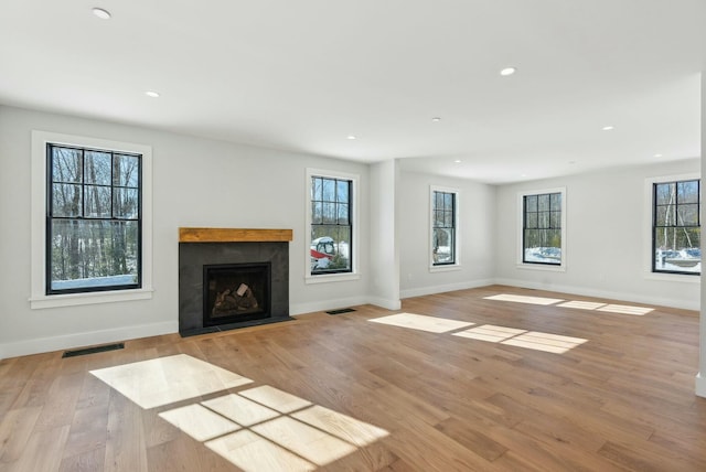 11 Acorn Ave, Kennebunkport, ME 04046 - unfurnished living room with recessed lighting, baseboards, light wood-type flooring, and a fireplace with flush hearth