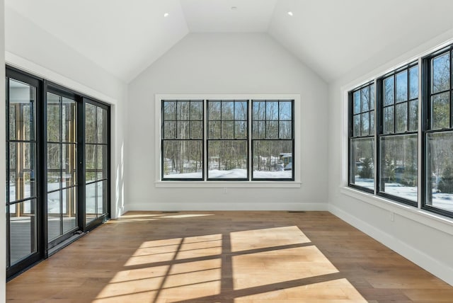 11 Acorn Ave, Kennebunkport, ME 04046 - empty room featuring healthy amount of natural light, wood finished floors, lofted ceiling, and baseboards