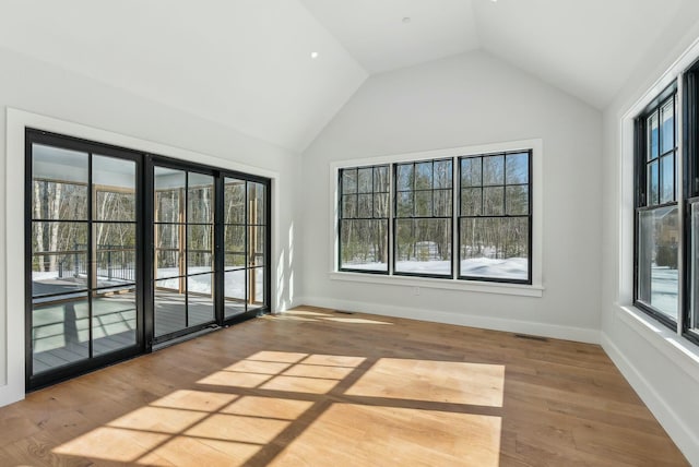 11 Acorn Ave, Kennebunkport, ME 04046 - empty room featuring lofted ceiling, wood finished floors, and baseboards