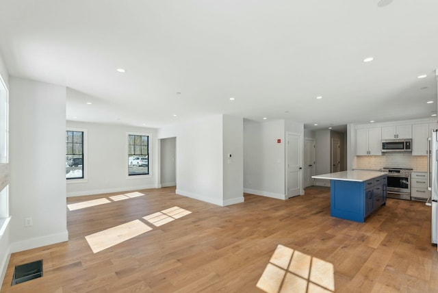 11 Acorn Ave, Kennebunkport, ME 04046 - kitchen with stainless steel appliances, open floor plan, backsplash, recessed lighting, and a center island