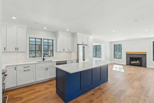 11 Acorn Ave, Kennebunkport, ME 04046 - kitchen with appliances with stainless steel finishes, a sink, recessed lighting, light wood-style floors, and decorative backsplash