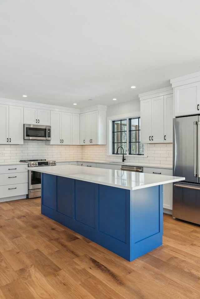 11 Acorn Ave, Kennebunkport, ME 04046 - kitchen with appliances with stainless steel finishes, a center island, backsplash, light countertops, and recessed lighting