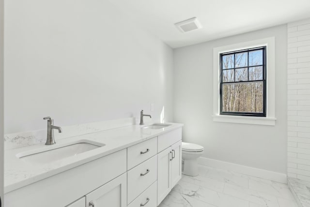 11 Acorn Ave, Kennebunkport, ME 04046 - full bathroom featuring marble look tiles, baseboards, toilet, and double vanity